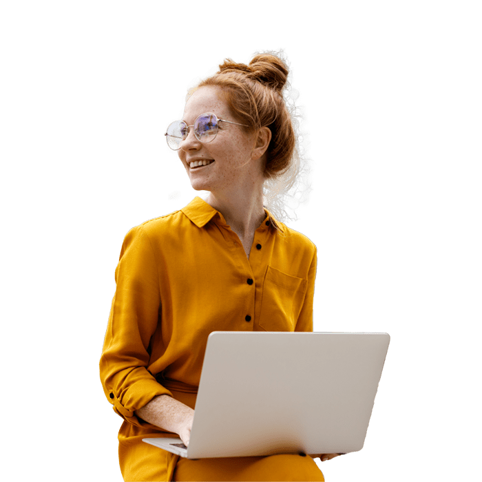 Young adult woman with glasses and laptop on her lap while looking to the right