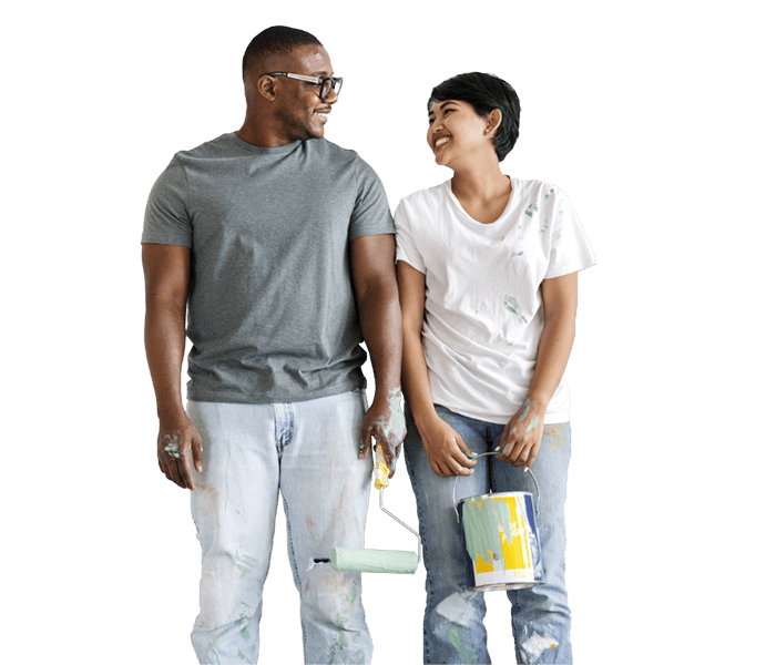 Couple looking at each other holding paint brush and paint can